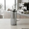 Minimalist glass mug with straw side view