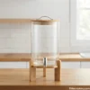 Glass Water Dispenser with Wooden Stand on Countertop Modern glass water dispenser with wooden stand in kitchen