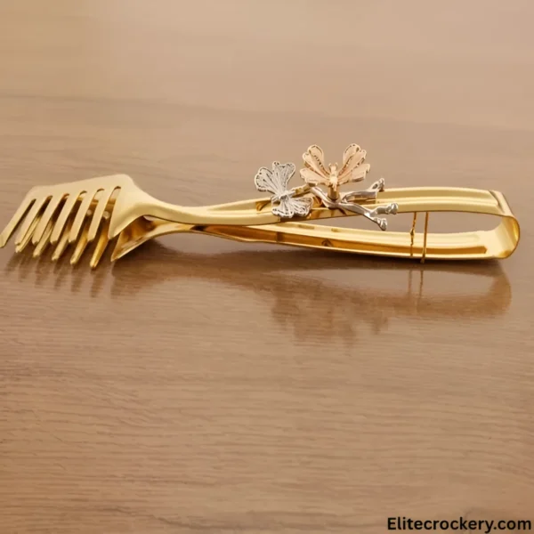 Angled view of butterfly gold kabab tong