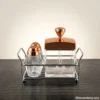 Crystal Salt and Pepper Shaker Set with rose gold accents on dark table