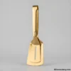 Gold premium serving tongs on light background