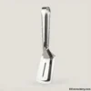 Silver premium serving tongs on light background