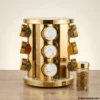 Filled glass jars inside golden rotating spice rack