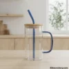 Glass mug with bamboo lid and blue straw