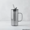 Empty minimalist glass mug with straw