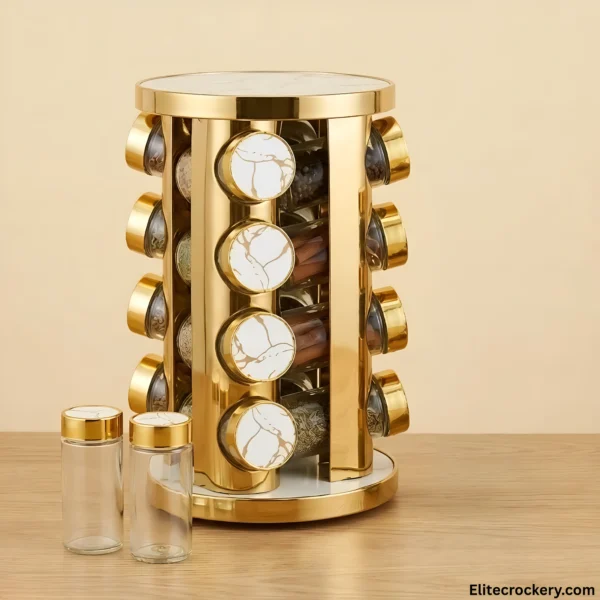 Golden rotating spice rack with glass jars on wooden table