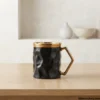 Luxury black ceramic mug on light wood table