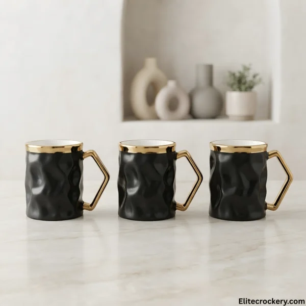 Array of three luxury black ceramic mugs with gold accents