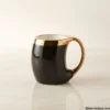Luxury black ceramic mug with ergonomic gold handle and gold rim