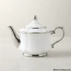 White teapot side view with silver accents