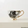 Luxury Ceramic Tea Cup Close-up of black floral ceramic tea cup with gold trim