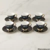Arrangement of six luxury tea cups and saucers on marble