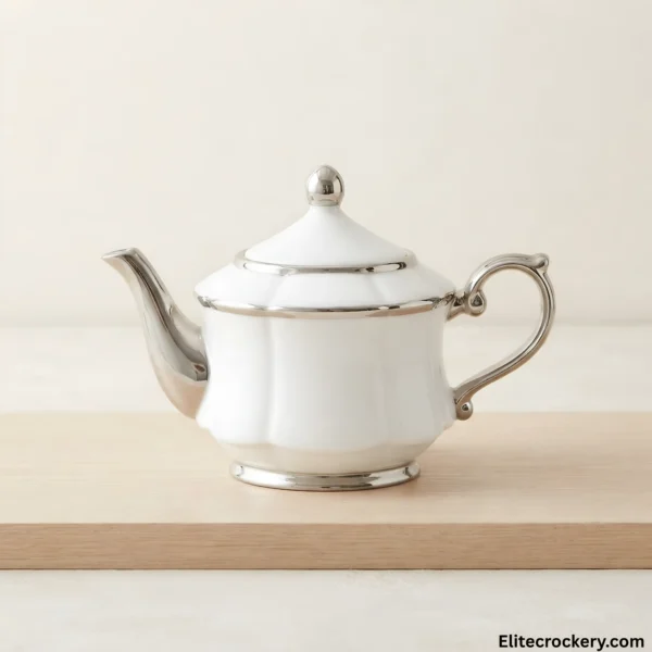 White ceramic teapot with silver trim